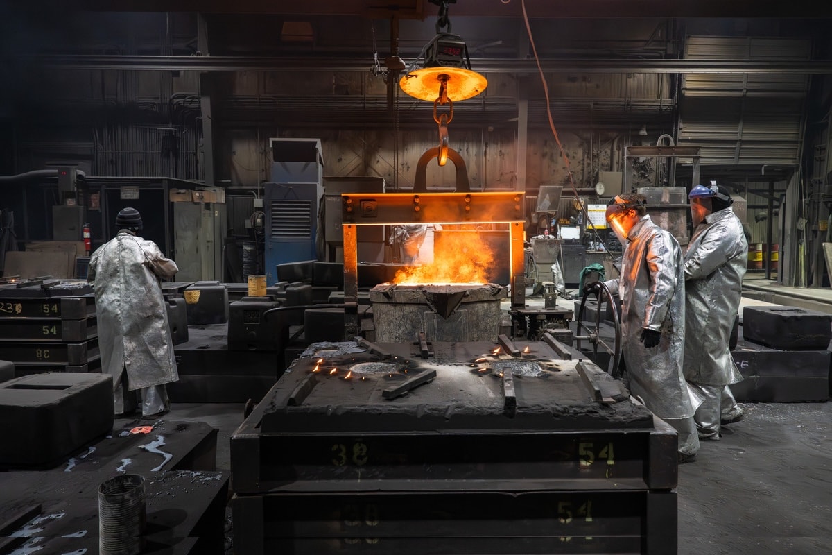 Workers at Anderson Foundries operating industrial forge