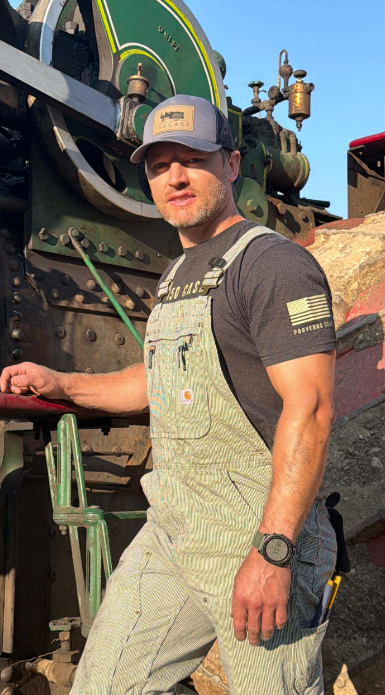 Kory Anderson wearing Carhartt bibs while working around the 150 HP Case steam tractor